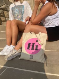 hot pink hi tote bag on steps with girls in sunshine